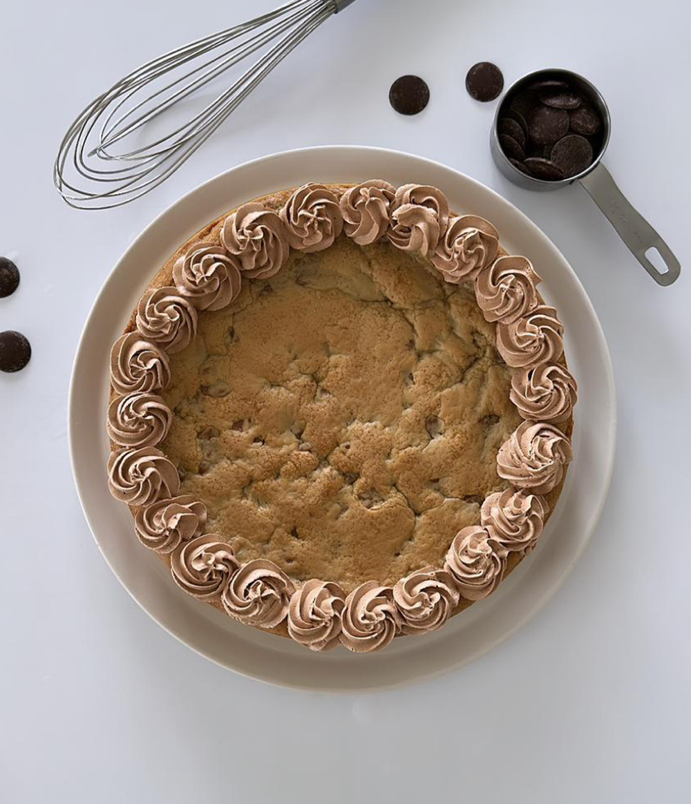 Buy Cookie Cake with Chocolate Chunks & Nutella Frosting from Poppylicious Bakery available online at VEND. Explore more desserts now